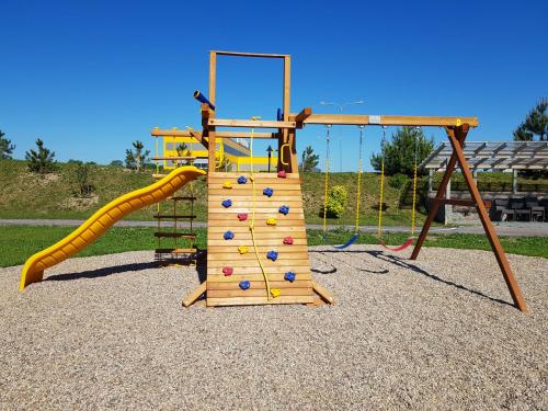 a playground with a slide and a climbing frame at Rezidencija Grįžulo ratai in Sasnava