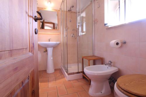 a bathroom with a sink and a toilet and a shower at B&B La Rocca in Caprarola