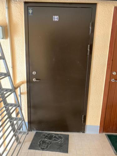 a black door with a sign on it at K84, Nice 2- bedroom apartment - 2 big beds 1 single bed in Tartu
