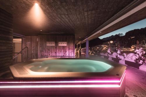 a jacuzzi tub in a house with a view at Anthony's Life&Style Hotel in Sankt Anton am Arlberg