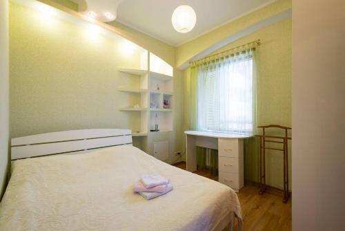 a small bedroom with a bed and a window at Nadezhda Apartments on Keremet in Almaty