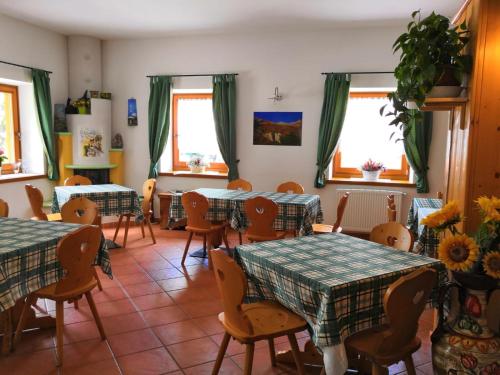 a restaurant with tables and chairs and windows at Affittacamere da Silvia in Santa Barbara