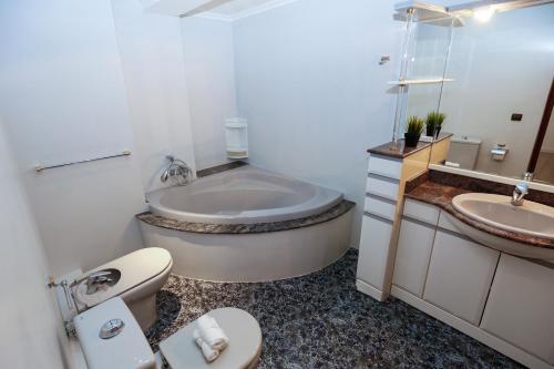 a bathroom with a tub and a toilet and a sink at Sobremar Planet Costa Dorada in Salou