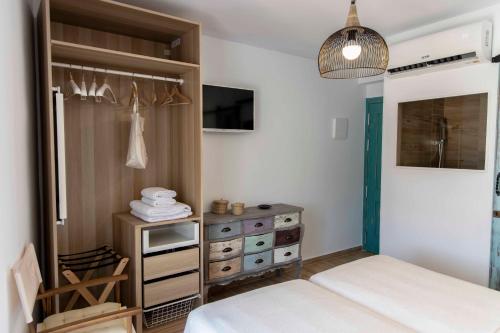 a bedroom with two beds and a dresser at Hostal Boutique Olvido 22 Adults Only in Peñíscola