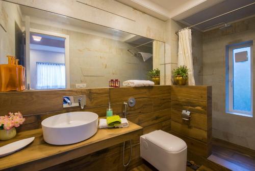 a bathroom with a sink and a toilet at EL Lodge by StayVista - Pool, lawn, and a charming gazebo for your perfect getaway in Lonavala