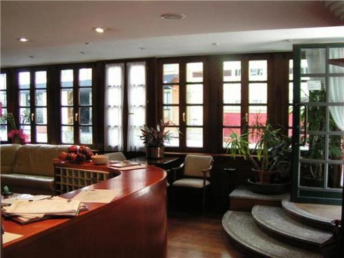 a lobby with a bar in a building with windows at La Plaza I in Luanco