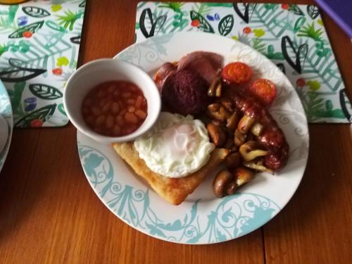 a plate of breakfast food with beans beans and eggs at Braeside B&B in Bushmills