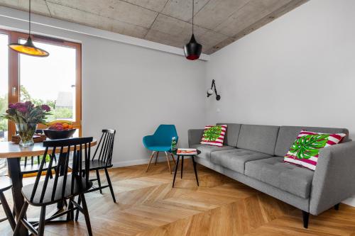 a living room with a couch and a table at Pogodna Apartments in Sopot