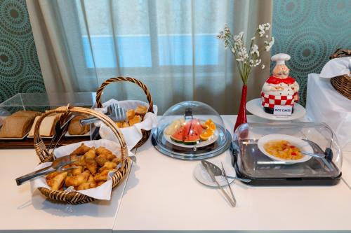 a table with some food and a basket of food at Alexis Hotel in Chania Town