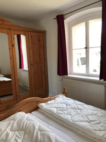 a bedroom with a bed and a large window at Hafenapartments Zingst in Zingst