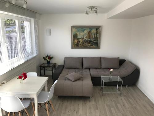 a living room with a couch and a table at Hafenapartments Zingst in Zingst