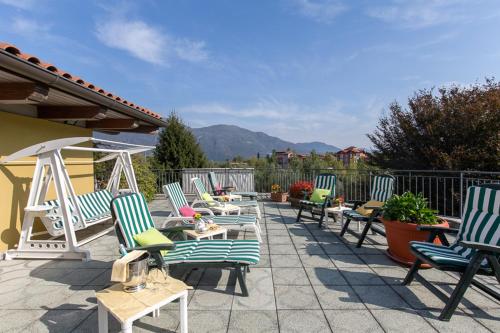 a group of chairs and tables on a patio at Hotel Del Fiume in Cannobio