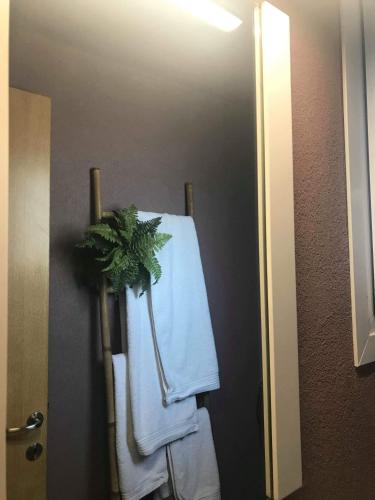 a towel rack with a plant on it in a bathroom at MILOS HOUSE in Afitos