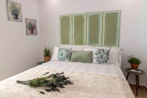 a bedroom with a white bed with a large window at Hostal Boutique Olvido 22 Adults Only in Peñíscola