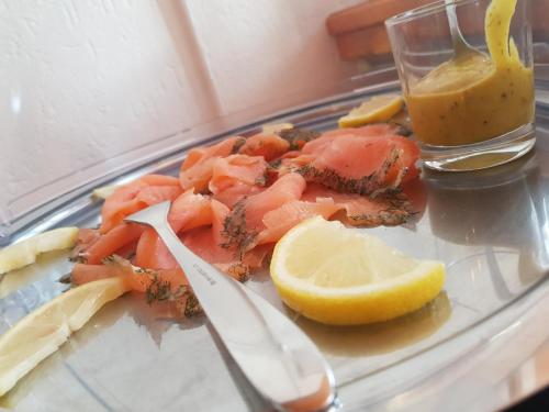 a plate of food with shrimp and a lemon at Ferienhaus am Rheintor in Andernach