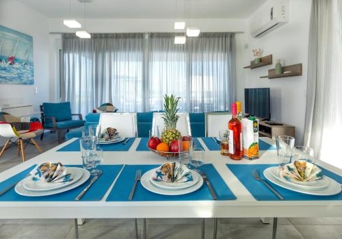 a table with plates of food on top of it at Aegean Horizon Beachfront Villas in Gennadi