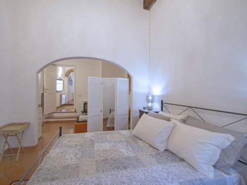 a bedroom with a bed and a large mirror at IL PRUNELLO - una casa tra le Torri in San Gimignano