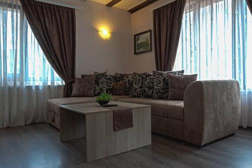 a living room with a couch and a table at СТАР МЕРАК in Ribarica