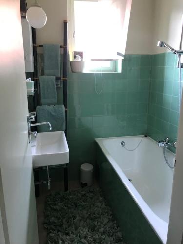 a bathroom with a tub and a sink and a bath tub at Anna & Ida in Reichenau