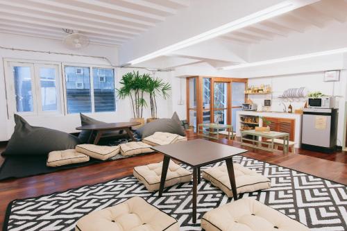 a living room with a couch and a table at Muan Hotel in Chiang Mai