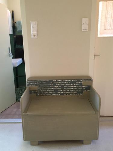 a room with a bench with words on it at Anna & Ida in Reichenau