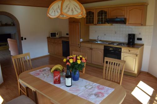 a kitchen with a table with flowers on it at Ferienwohnung Kagerbauer Christiane in Lindberg