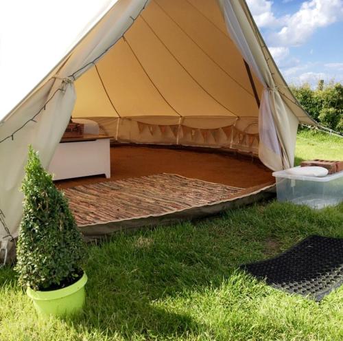 a tent with a bed in the grass at Wold Farm Bell Tents in Flamborough
