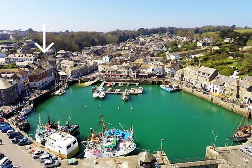 a group of boats are docked in a harbor at TOWN CENTRE apartment dogs welcome in Padstow