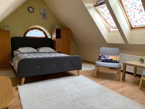 a bedroom with a bed and a chair at Apartamenty w Ustroniu in Ustroń