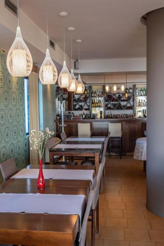 a row of tables in a restaurant with lights at Alexis Hotel in Chania Town