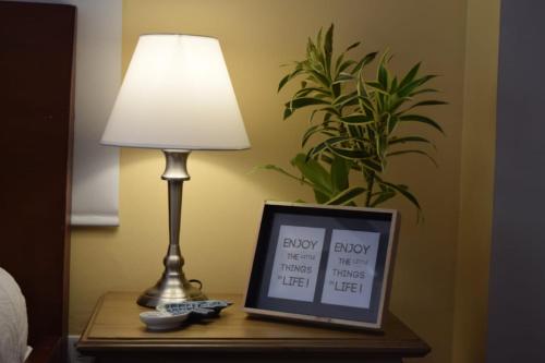 a table with a lamp and a picture on it at Porto Bello Hotel Boutique in Puerto Colombia