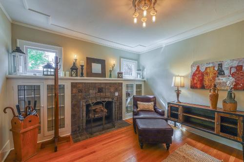 a living room with a fireplace and a chair at Lakefront Craftsman in Seattle