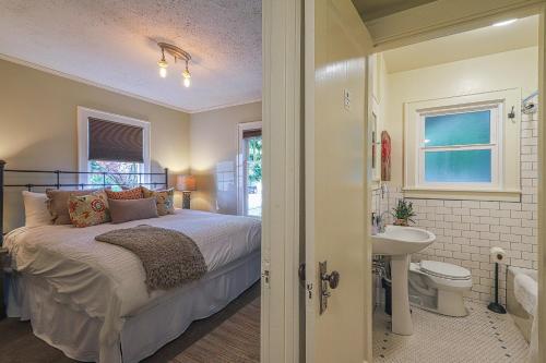 a bedroom with a bed and a bathroom with a sink at Lakefront Craftsman in Seattle