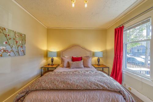 a bedroom with a bed with two lamps and a window at Lakefront Craftsman in Seattle