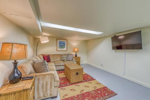 a living room with a couch and a flat screen tv at Lakefront Craftsman in Seattle