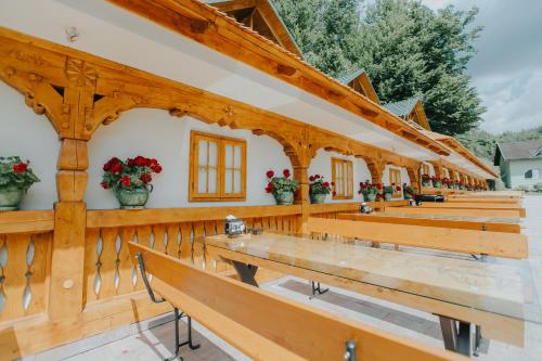a row of benches in a building with flowers at Lostrita - Pastravarie, Hotel & SPA in Baia Mare