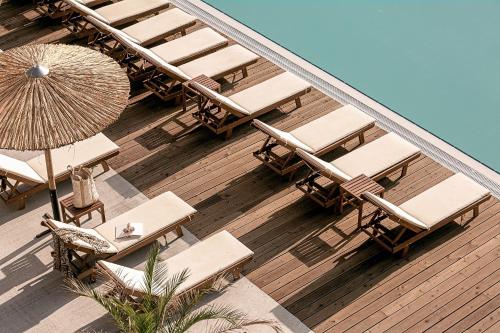 an overhead view of a deck with chairs and an umbrella at Sunny Beach Club - Adults Only #YouthfulVibes in Sunny Beach