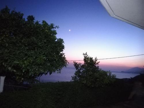 a view of the ocean at sunset from a house at Eduard Lagji Apartament in Lukovë