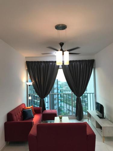 a living room with a red couch and a large window at The Zizz Homestay@Damansara Damai in Petaling Jaya