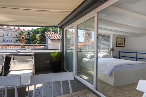 Schlafzimmer mit einem Bett auf einem Balkon in der Unterkunft Apartment Sebastijan in Piran