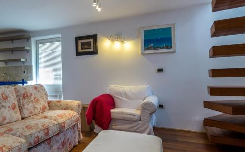 a living room with a couch and a chair at Apartment Sebastijan in Piran
