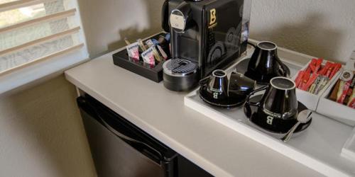 a counter with a coffee maker on top of it at The Reserve Boutique Hotel in Hazyview