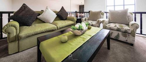 a living room with two couches and a coffee table at The Lodge at Atlantic Beach in Melkbosstrand