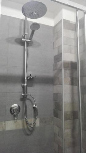 a shower with a glass door in a bathroom at B&B TERRA DI MITI in Acireale