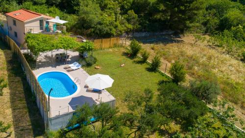 an aerial view of a backyard with a pool and a house at Holiday Home Rupotina with a large yard, pool and a beautiful view in Solin
