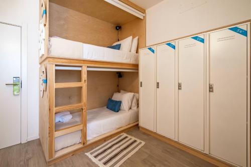 a bunk bed in a room with two bunk beds at Wavesensations - Sagres Surf House in Sagres