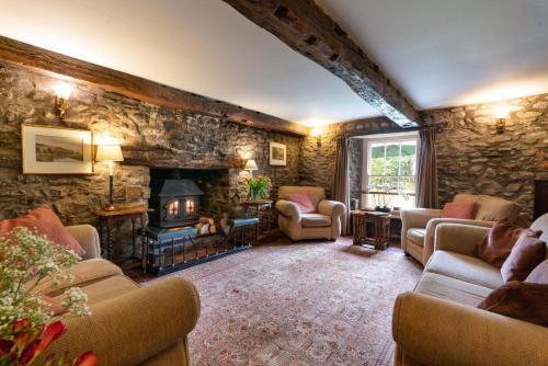 a living room with stone walls and a fireplace at Ty Mawr Country Hotel & Restaurant in Carmarthen