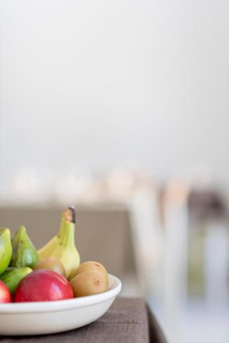 a bowl of fruit on a table with a plate of fruit at BnB FICO in Lecce