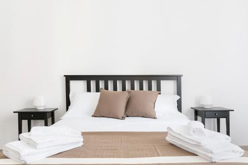 a bed with white sheets and pillows on it at BnB FICO in Lecce