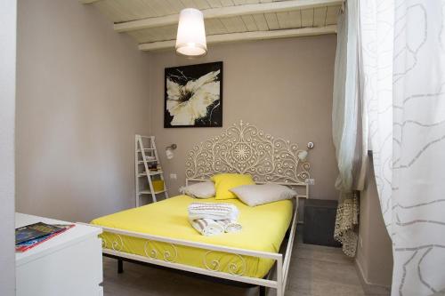 a small bedroom with a yellow bed in a room at Villa Sea Rose in Lipari